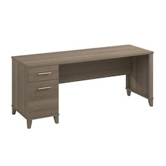 Gray office desk with drawers and wire management for computer workstations