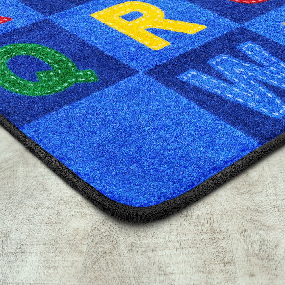 Kid Essentials Patchwork Letters 7'8" x 10'9" Area Rug in Color Multi. Picture 2