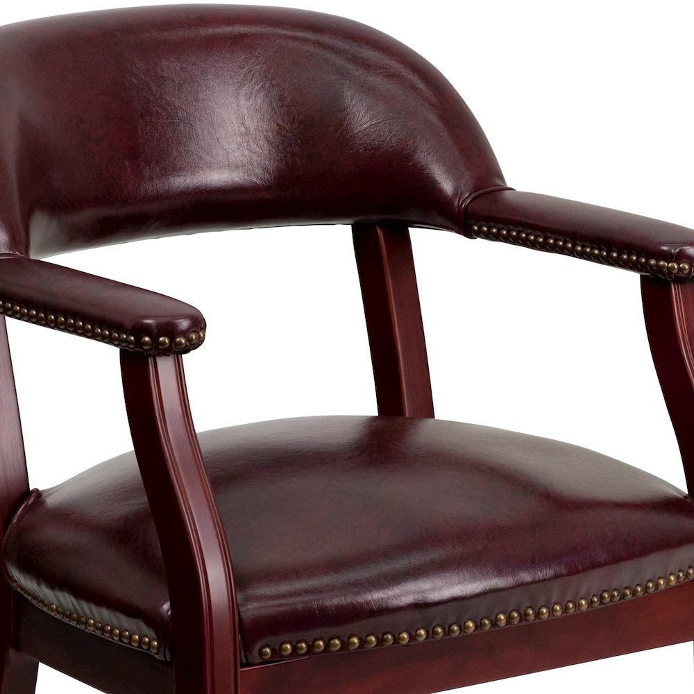 Oxblood Vinyl Luxurious Conference Chair with Accent Nail Trim and Casters. Picture 7