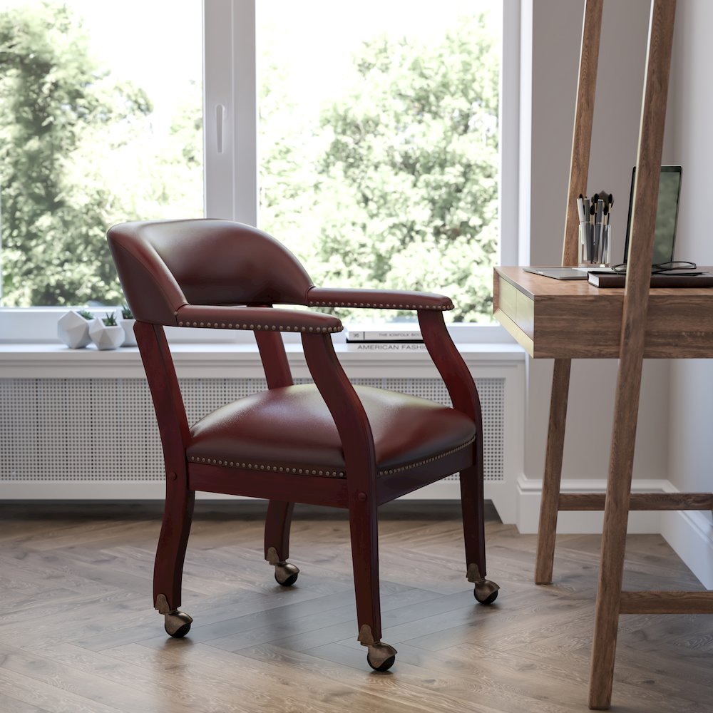 Oxblood Vinyl Luxurious Conference Chair with Accent Nail Trim and Casters. Picture 2