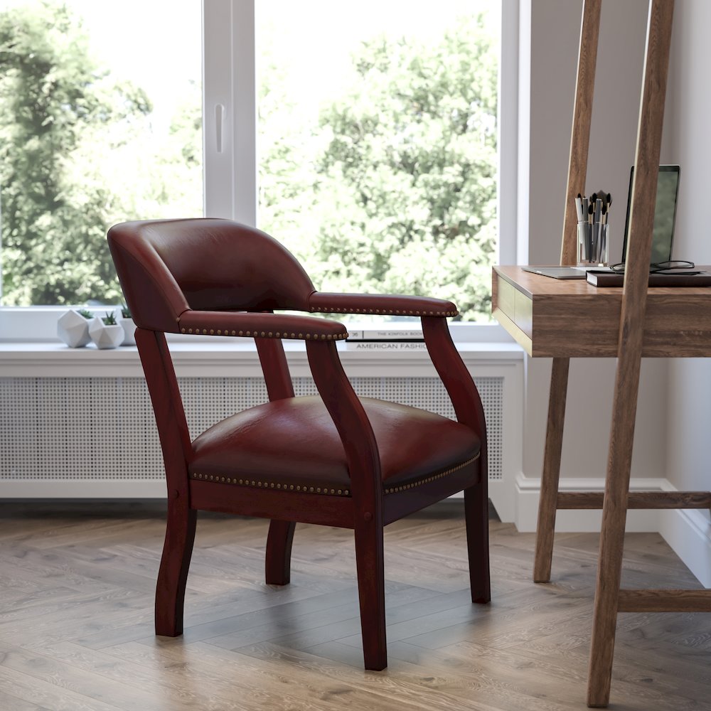 Oxblood Vinyl Luxurious Conference Chair with Accent Nail Trim. Picture 2
