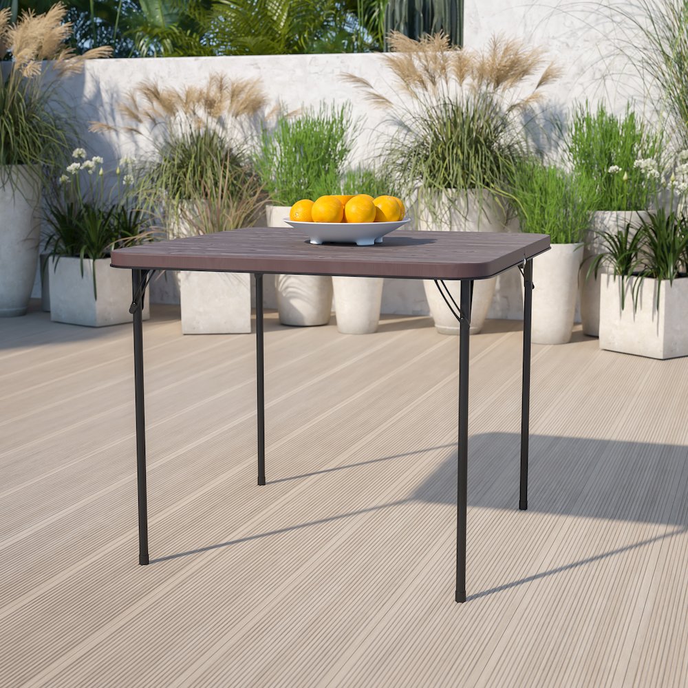 2.83-Foot Bi-Fold Brown Wood Grain Plastic Folding Table with Carrying Handle. Picture 2