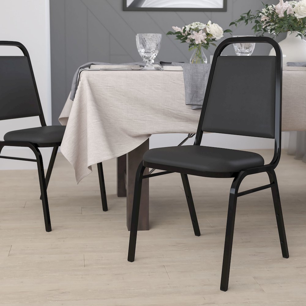 Trapezoidal Back Stacking Banquet Chair in Black Vinyl - Black Frame with 1.5" Thick Seat. Picture 9