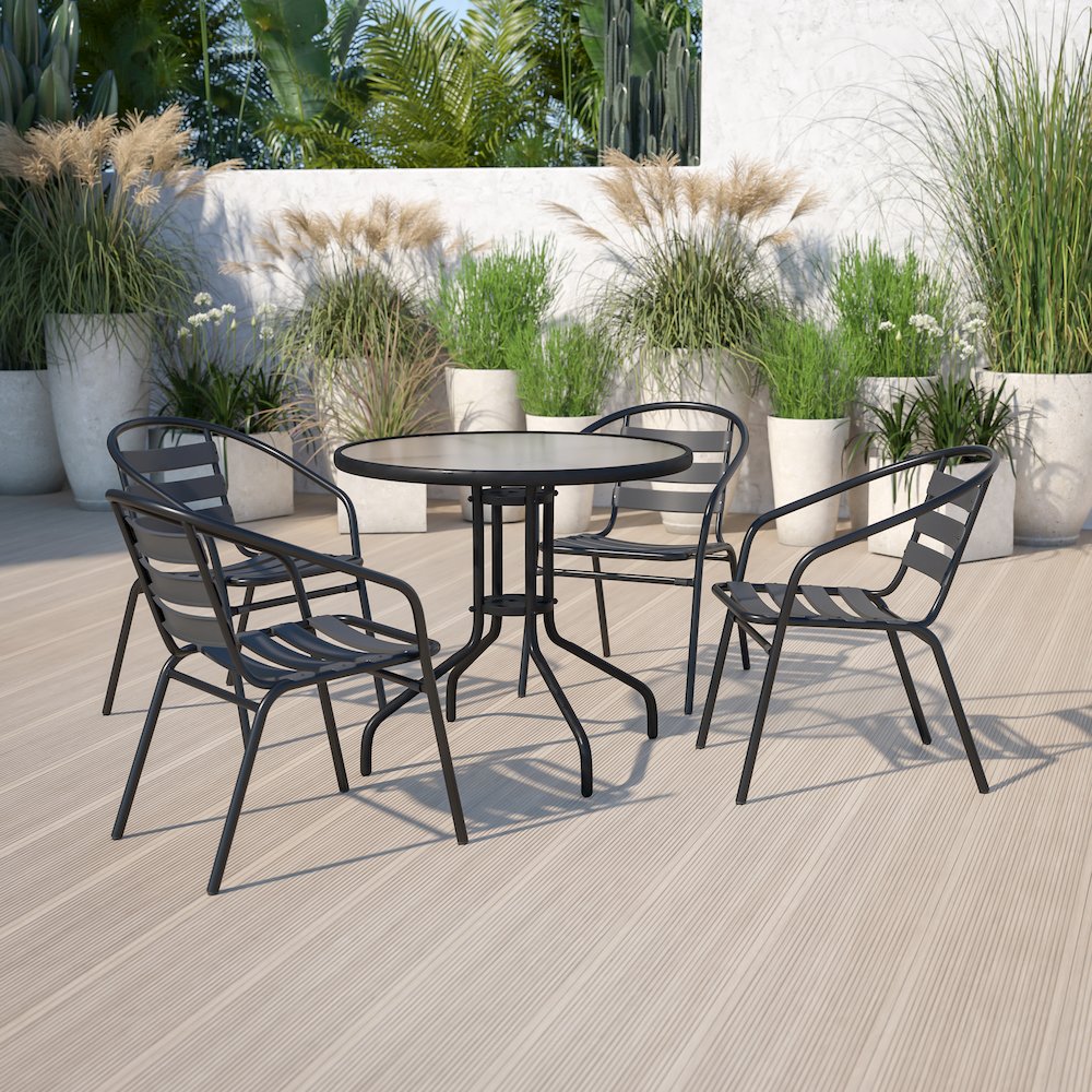 31.5'' Round Glass Metal Table with 4 Black Metal Aluminum Slat Stack Chairs. Picture 4
