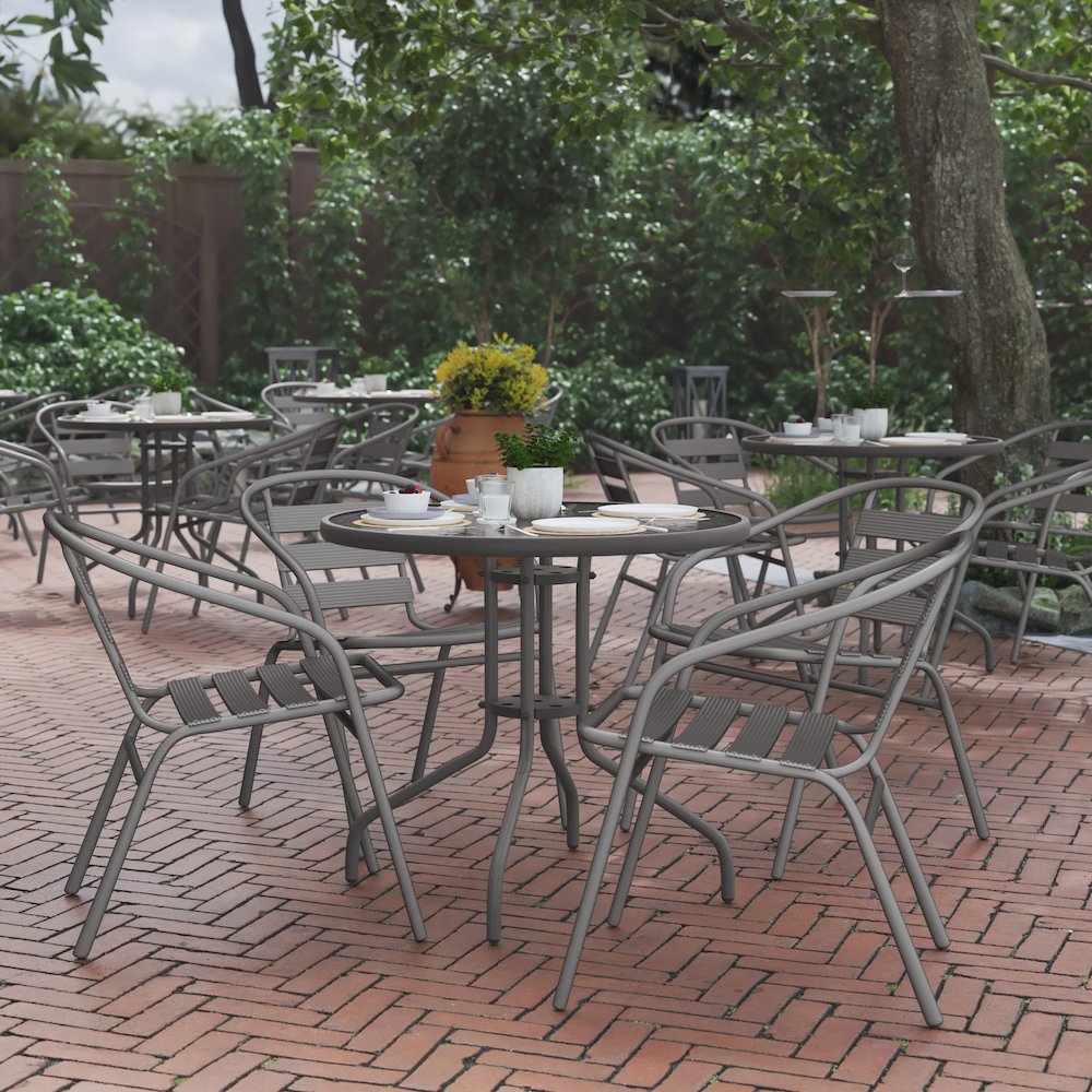 Lila 31.5'' Round Glass Top Metal Table with 4 Silver Aluminum Slat Stack Chairs. Picture 3