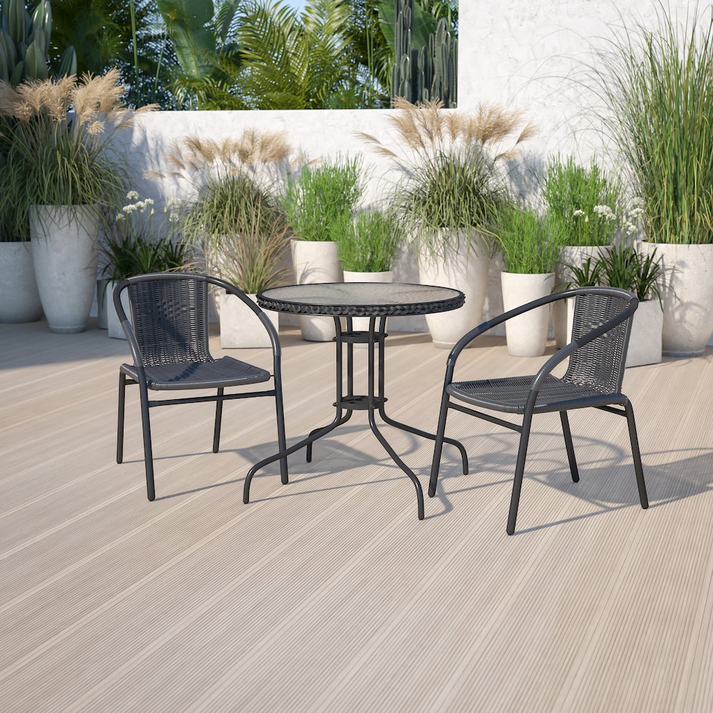 28'' Glass Metal Table with Black Rattan Edging and 2 Black Rattan Stack Chairs. Picture 2
