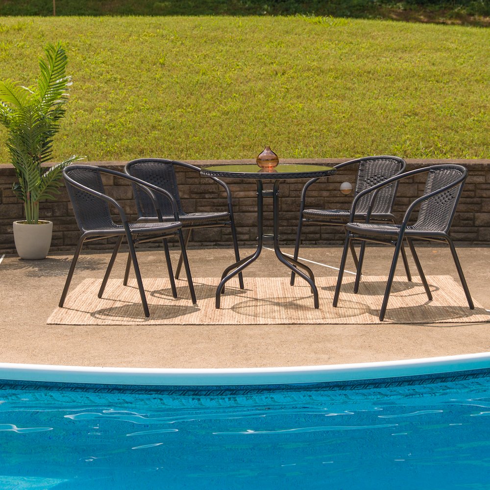 28'' Glass Metal Table with Black Rattan Edging and 4 Black Rattan Stack Chairs. Picture 2