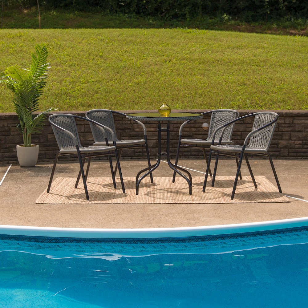 28'' Round Glass Metal Table with Gray Rattan Edging and 4 Gray Rattan Stack Chairs. Picture 7