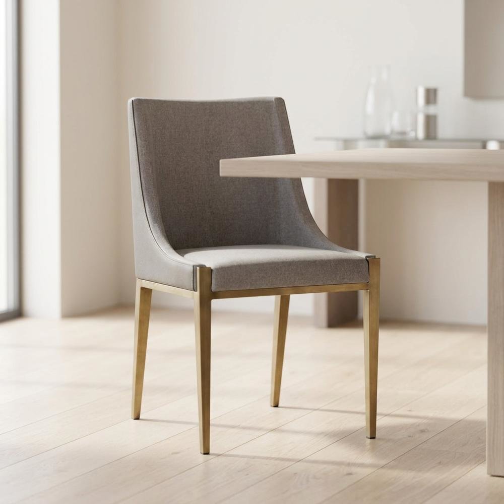 Modern grey and brass dining chair with padded seat and sleek design. Picture 3