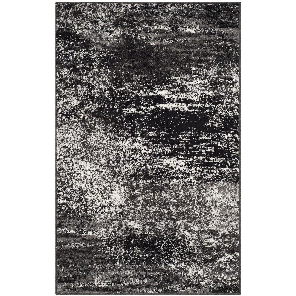 Gray and Black Area Rug with Power Loomed Polypropylene Pile for Accent Spaces. Picture 1