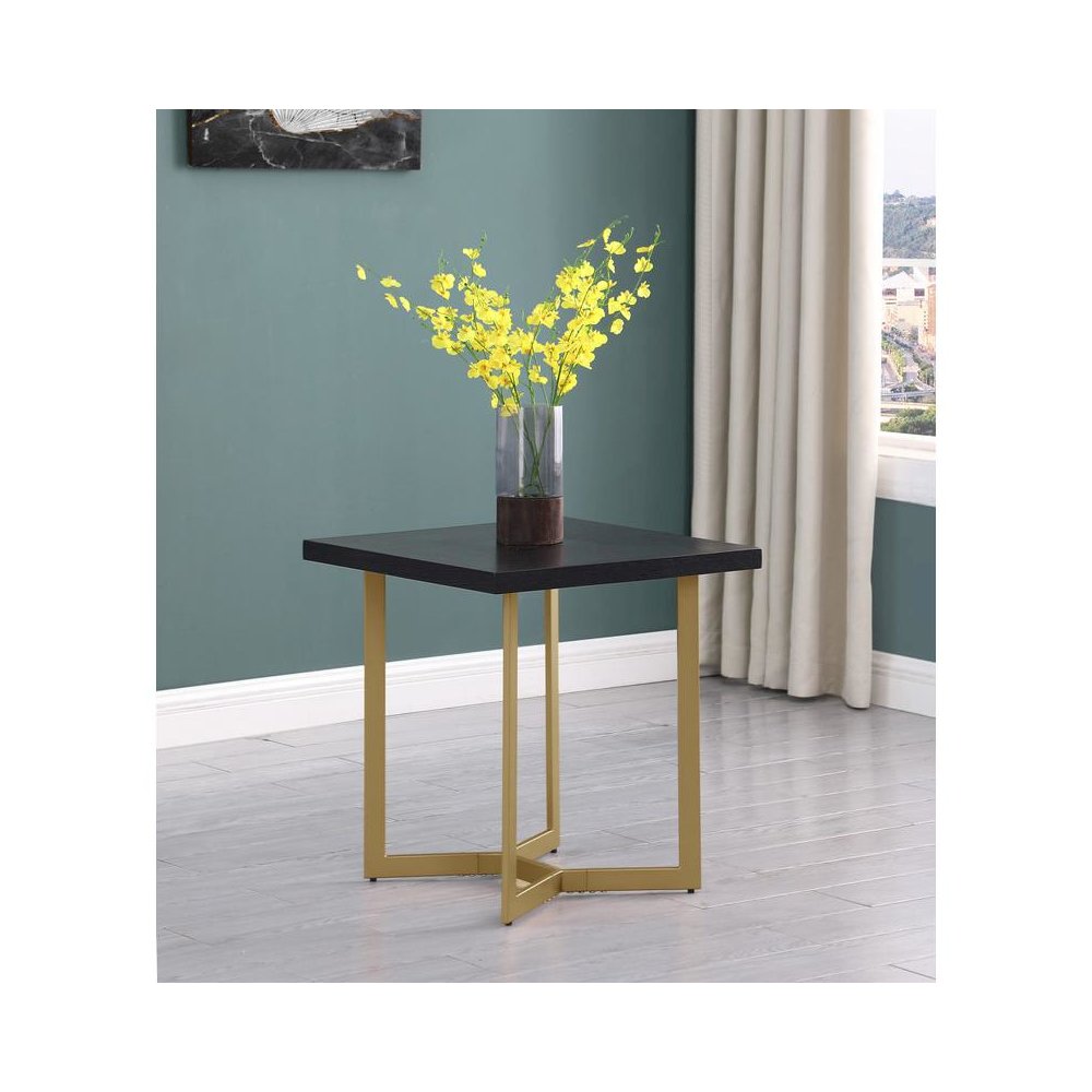 Black wood top end table w/ gold color iron legs. Picture 2