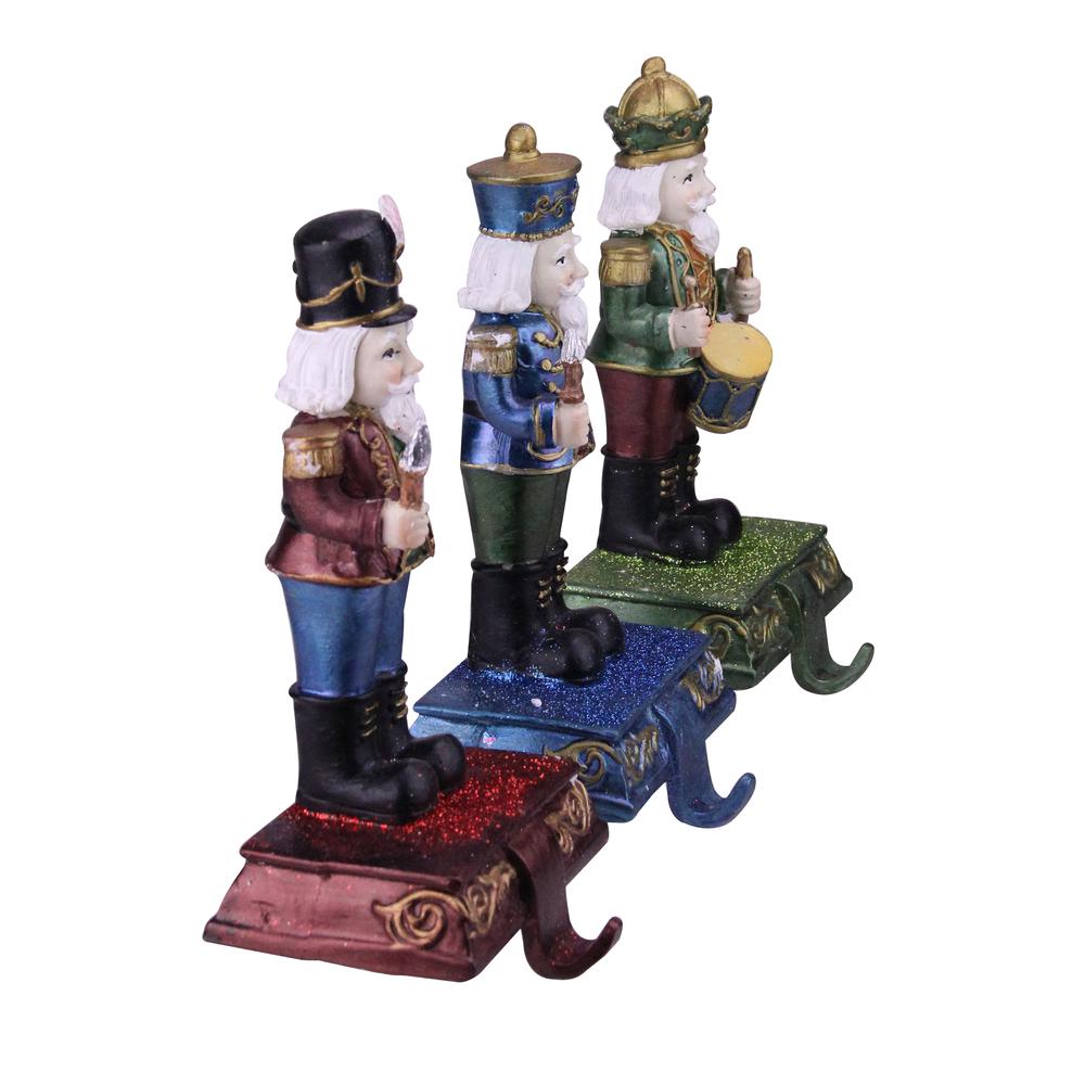 Set of 3 Blue  Red and Green Glittered Nutcracker Stocking Holders 7.75". Picture 2