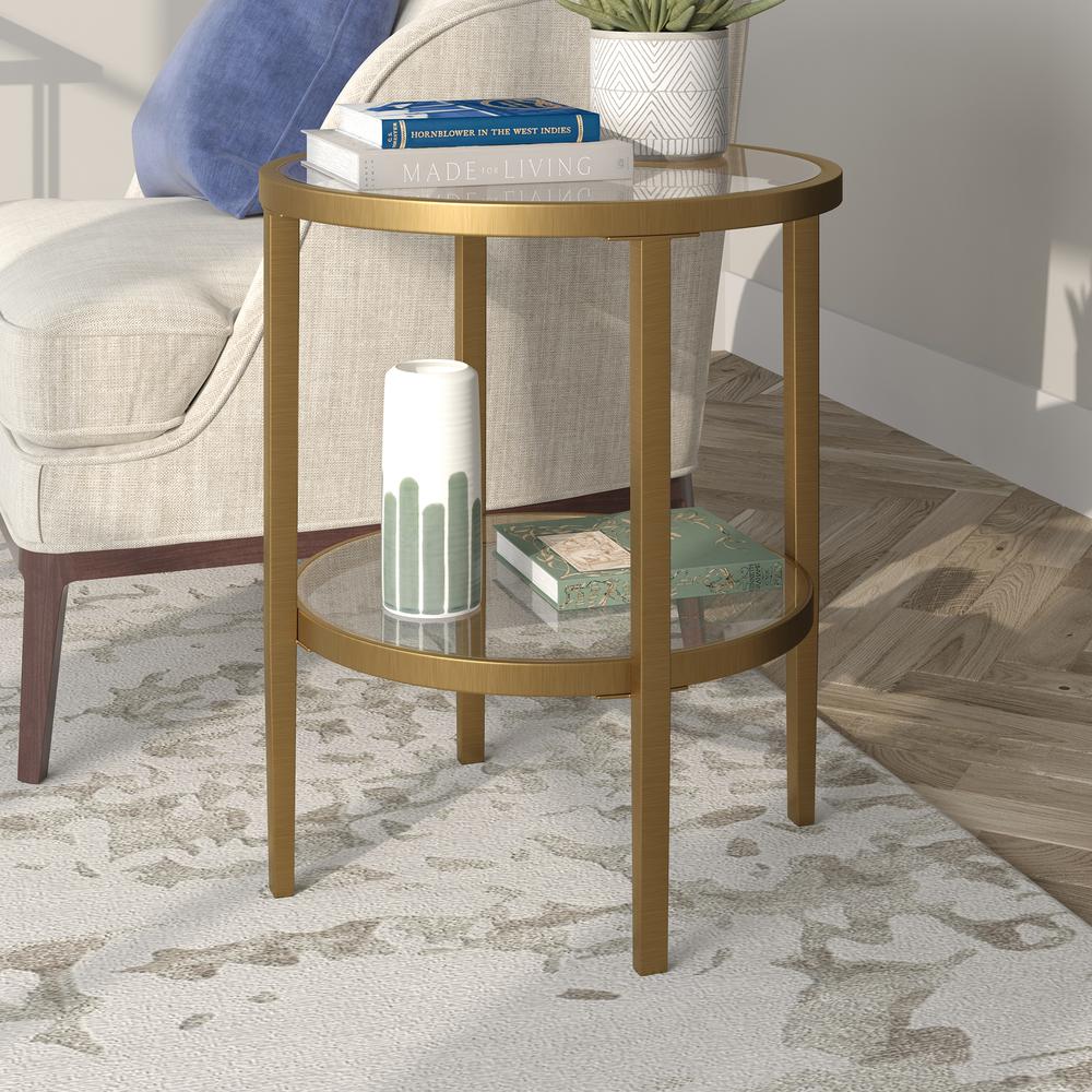Hera 19.63'' Wide Round Side Table with Clear Glass Shelf in Antique Brass. Picture 2