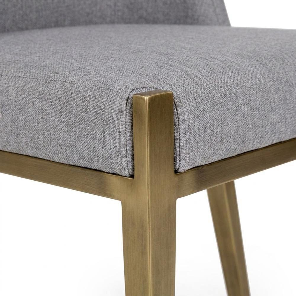 Modern grey and brass dining chair with padded seat and sleek design. Picture 6