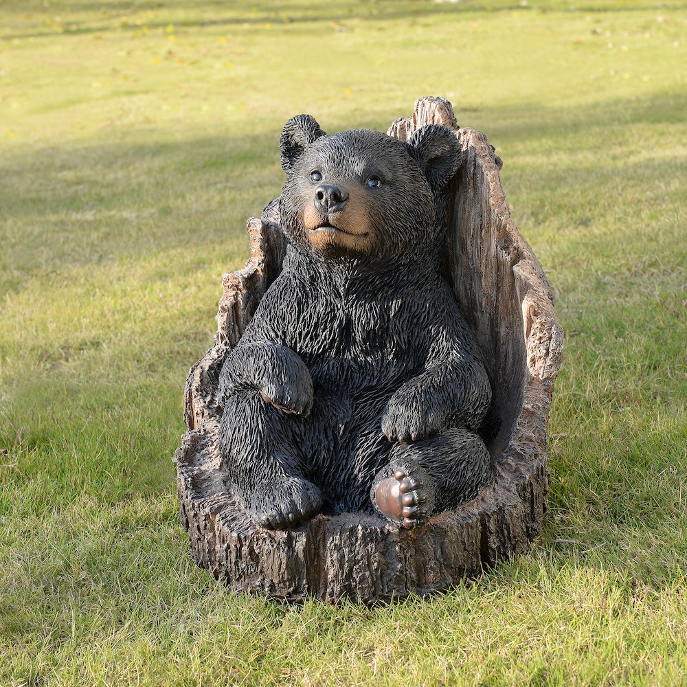 Lone Cub Haven: Intriguing Black Polyresin Bear in Stump Figurine. Picture 2