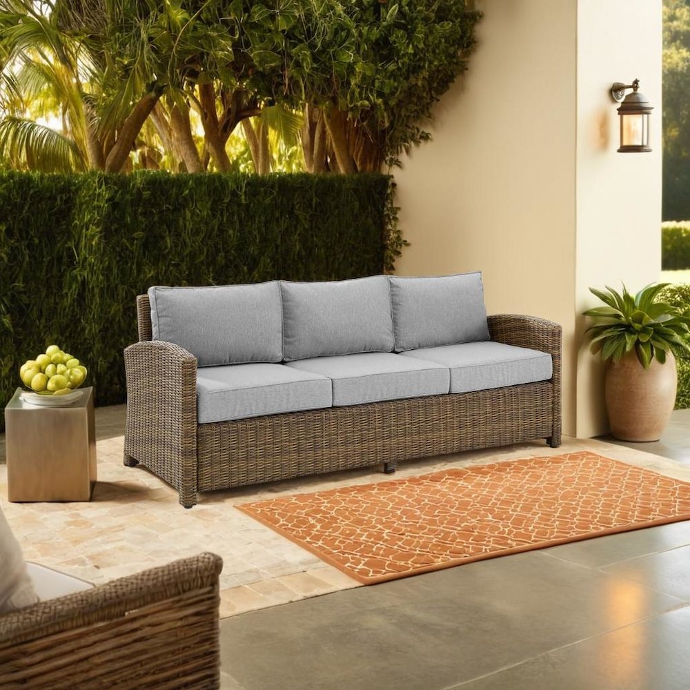 Elegant Gray Wicker Outdoor Sofa with Weather-Resistant Cushion Covers. Picture 4